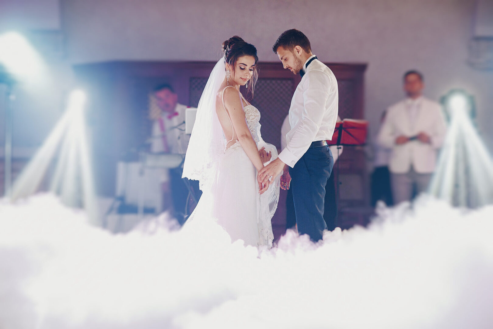 the bride and her husband dance together their first wedding dance in the restaurant